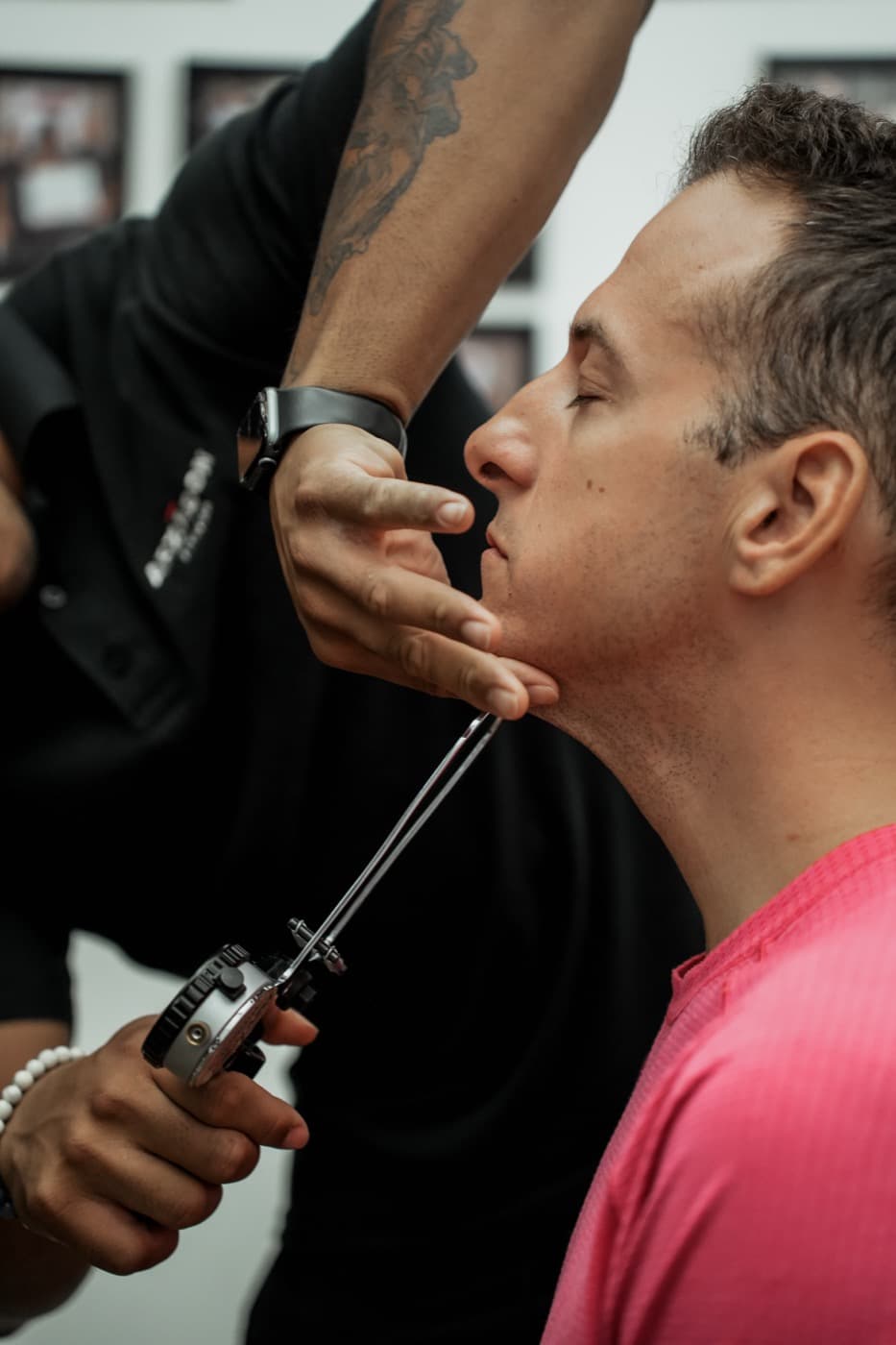 Trainer uses biosignature caliper to measure jaw fat fold on male client at Arzadon Fitness Toronto