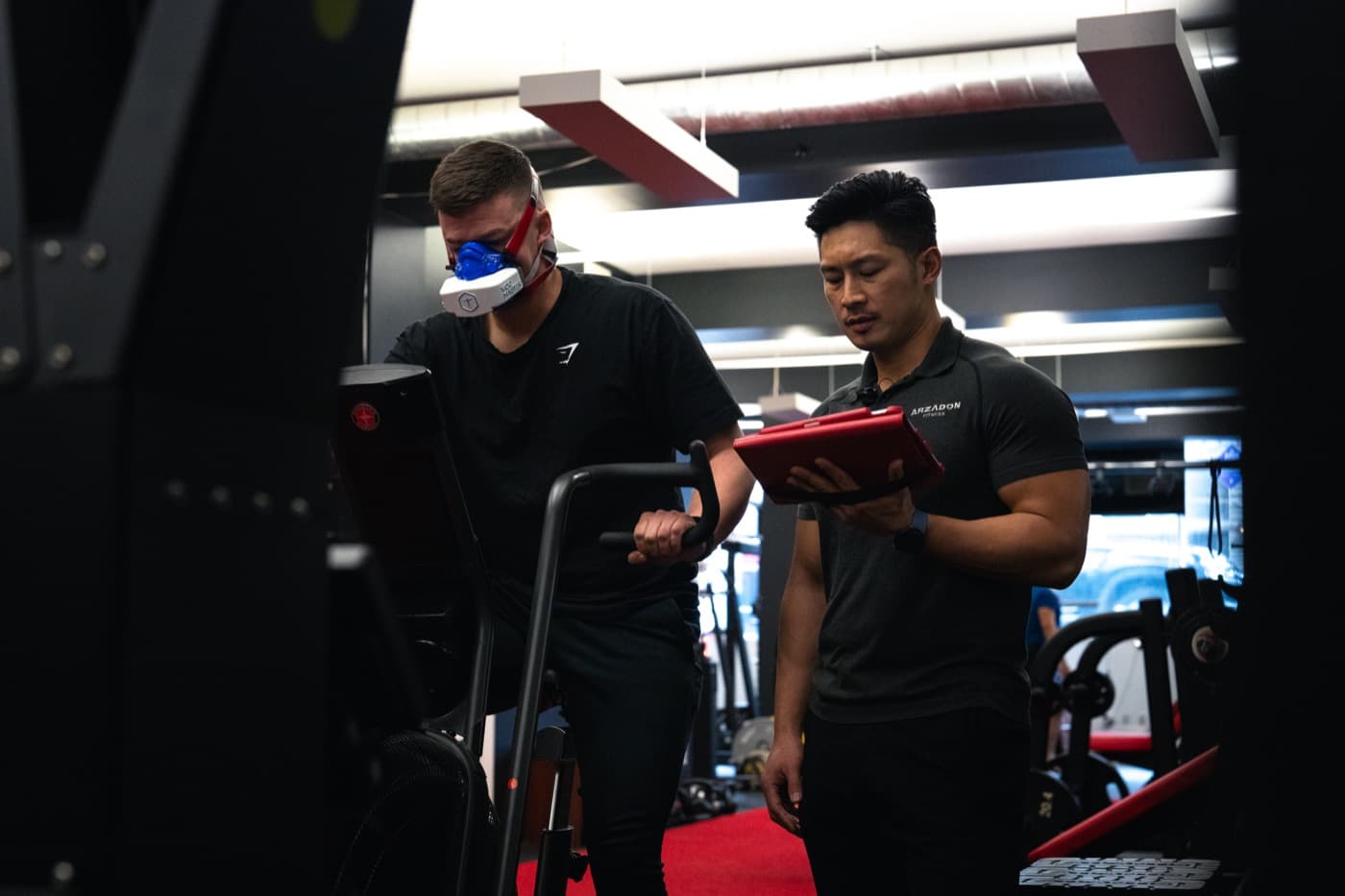Client wearing VO2 max respiratory mask on stationary bike during fitness assessment at Arzadon Fitness Toronto
