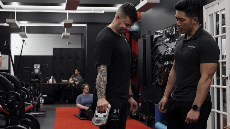 Coach reviewing body composition data that drives a client's nutrition plan at Arzadon Fitness Toronto