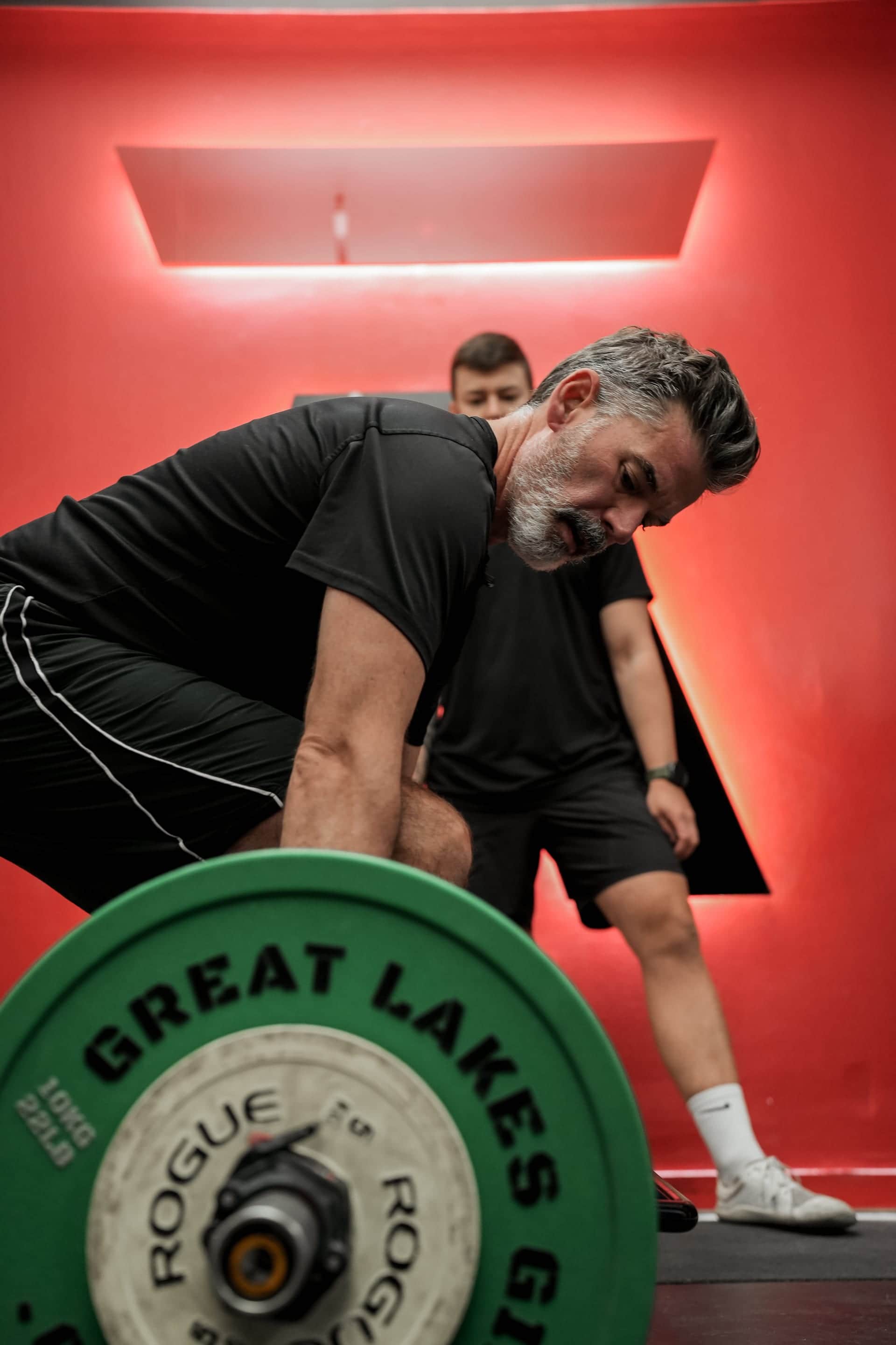 Arzadon Fitness trainer coaching a client during barbell deadlift in Toronto
