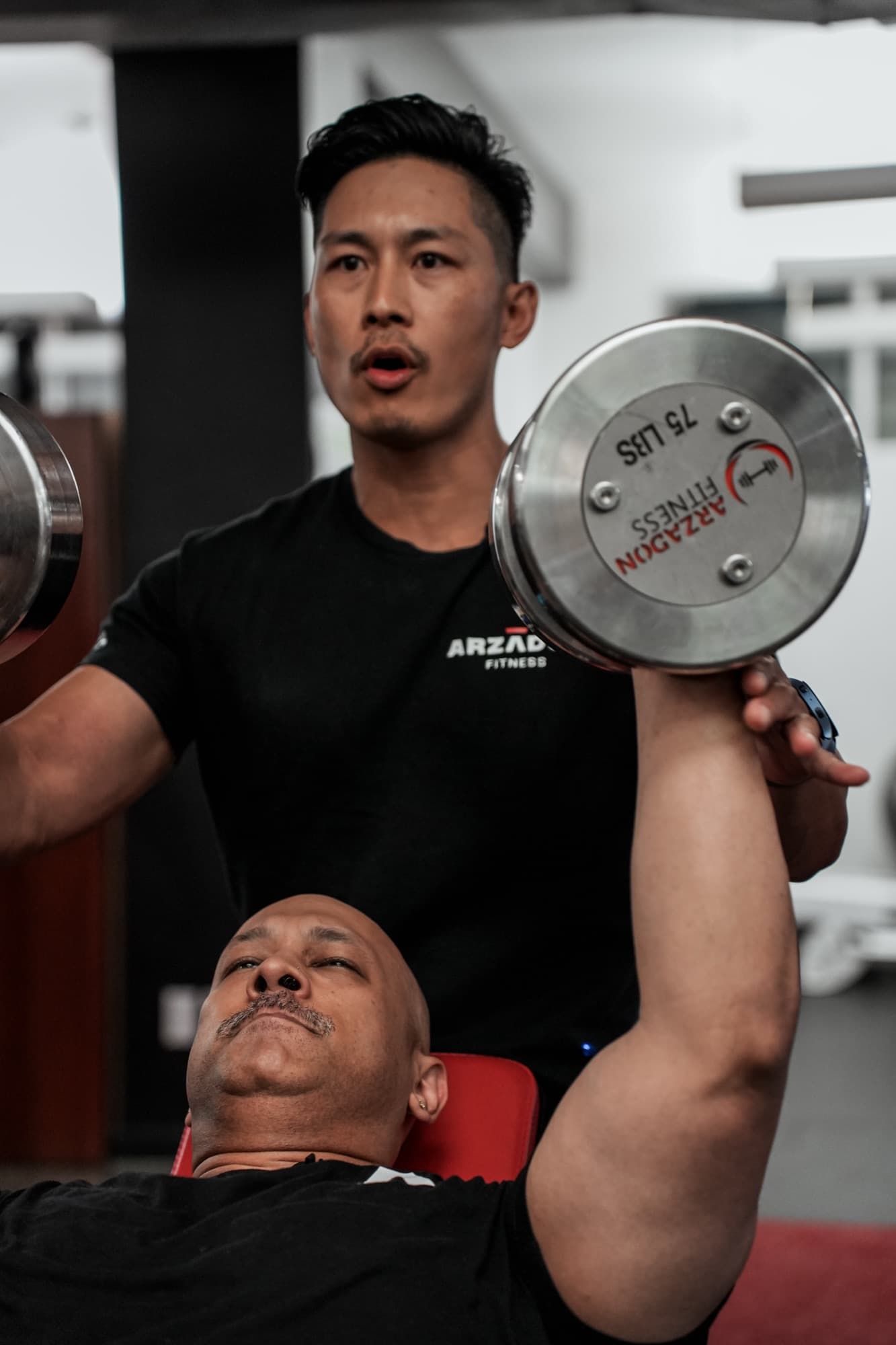 Trainer leading custom program design consultation at Arzadon Fitness Toronto