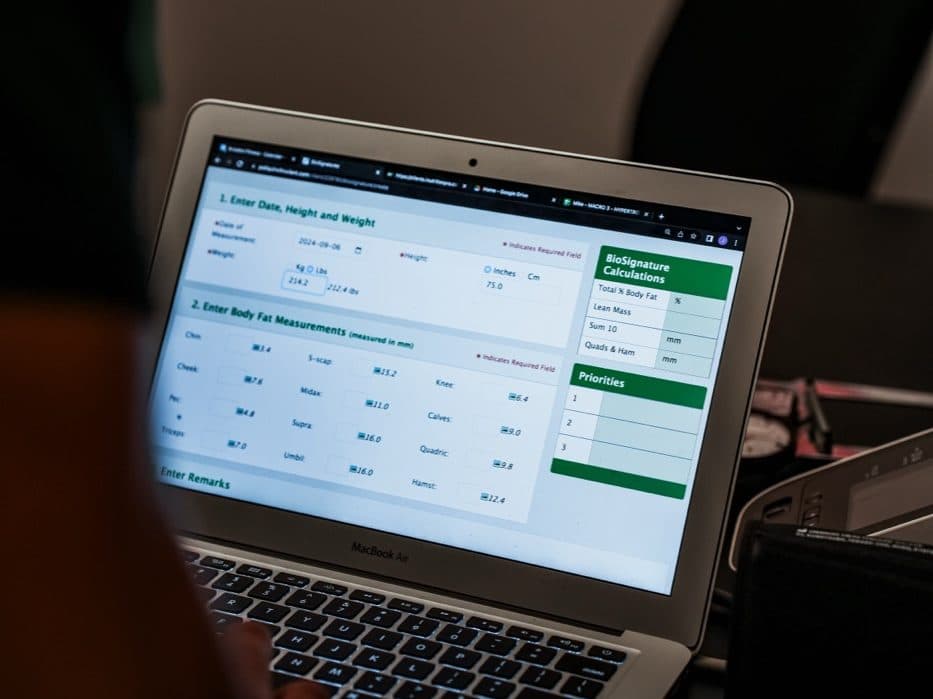 MacBook Air displaying BioSignature body fat calculation form at Arzadon Fitness Toronto