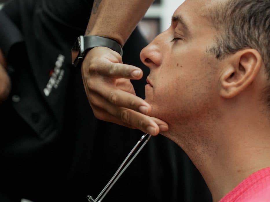 Trainer using biosignature caliper to measure jaw skinfold on male client at Arzadon Fitness Toronto